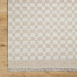 Clinten Solid and Border Tan Area Rug