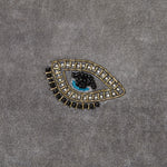 Embroidered evil eye pillow, grey cotton velvet