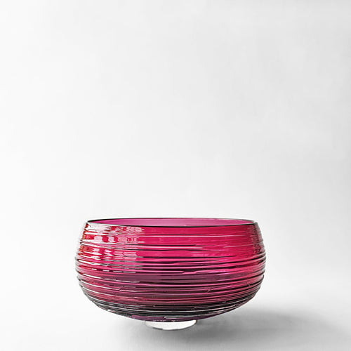 Magenta glass decorative bowl.