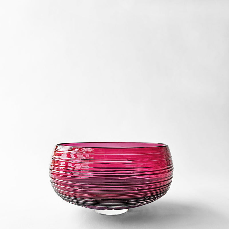 Magenta glass decorative bowl.